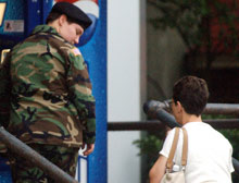 Pfc. Lynndie England, left, looks back at her mother, Terrie, as she enters the Judge Advocate Building